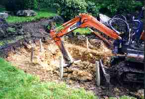 Using the mini digger to dig the main section of the pond