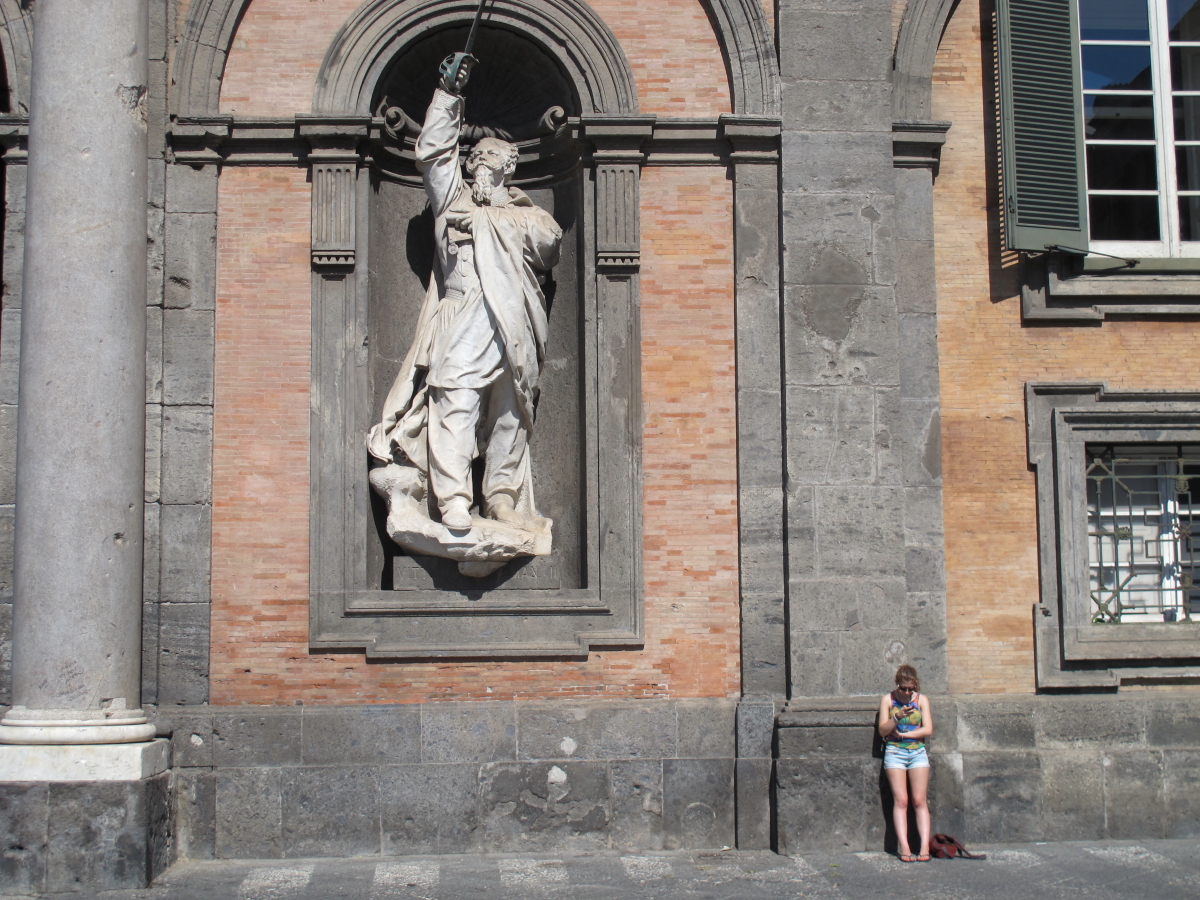 Looking at phone in piazza del plebiscito