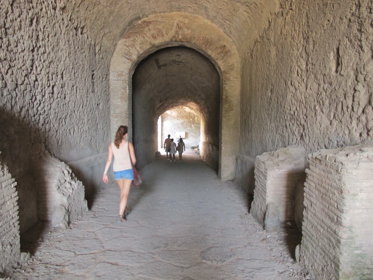 People entering the amphitheatre through short tunnel