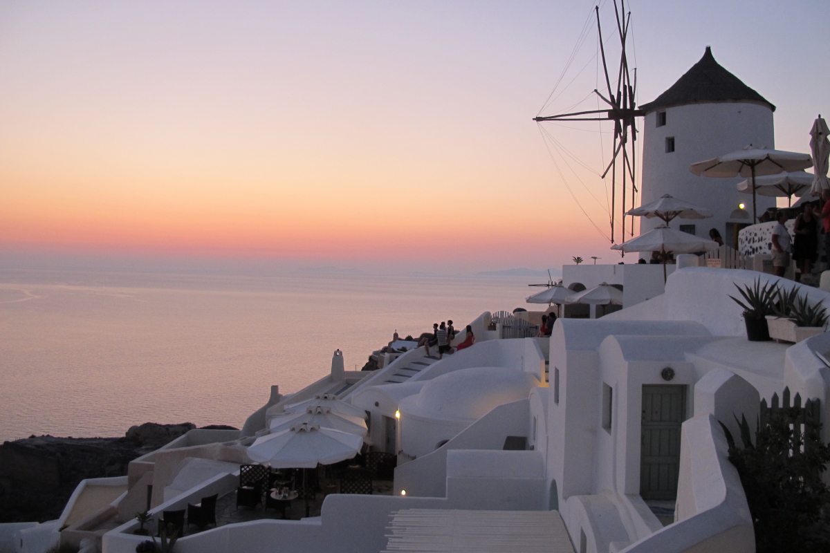 Santorini - sunset over sea with windmill on right