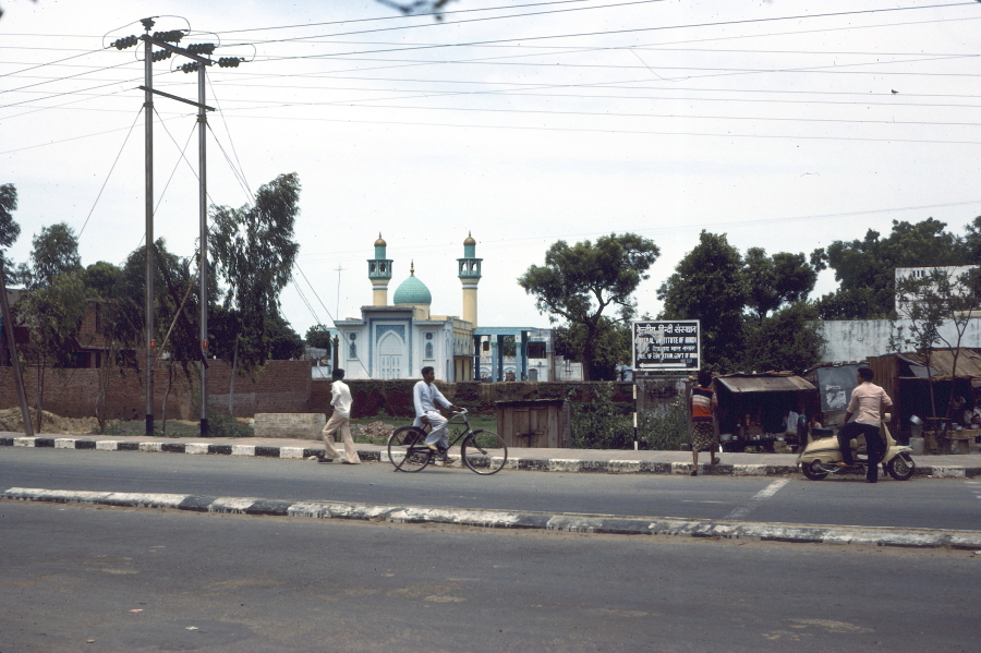 Man cycling along main road in Agra