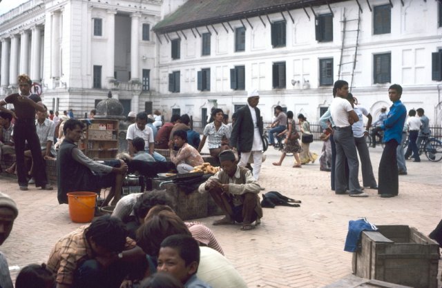 Crowded square, groups of people working and chatting