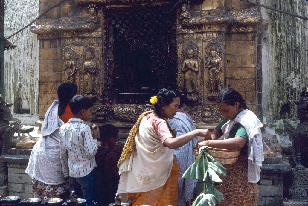 Women making offerings at the template