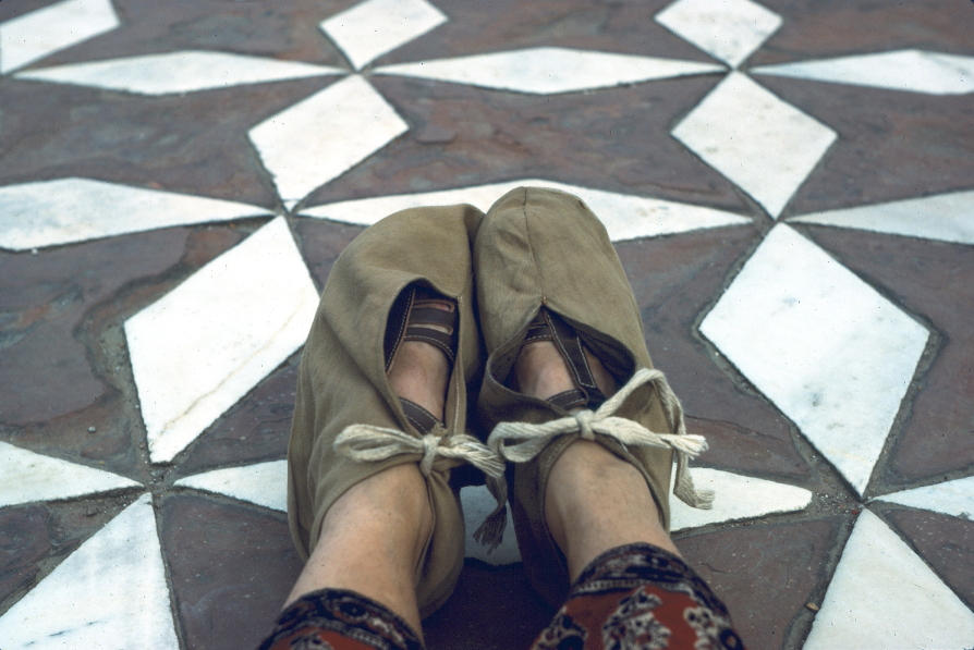 My dusty feet and sandals in shoe covering