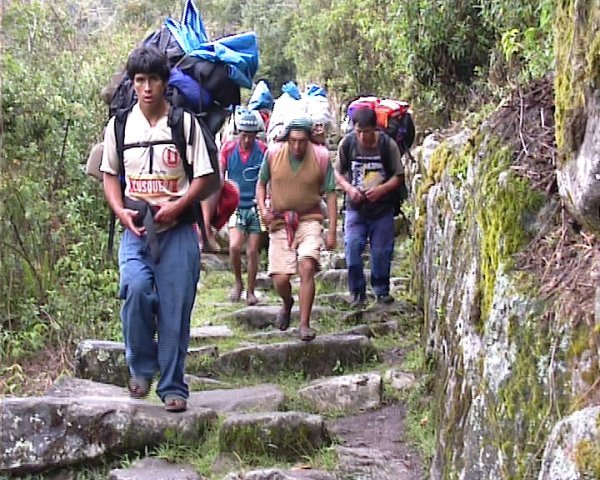 people with backpacks walking the last part of the Inca trail 