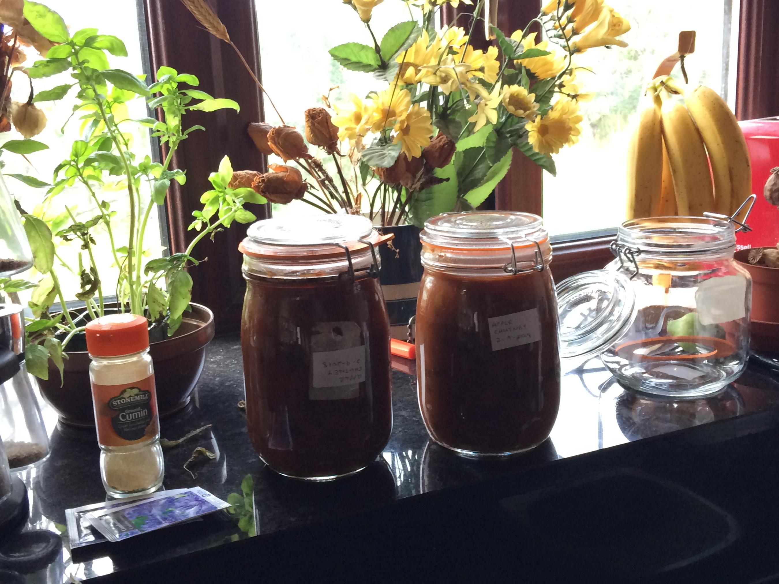 Two 1 litre jars of apple chutney on window cill